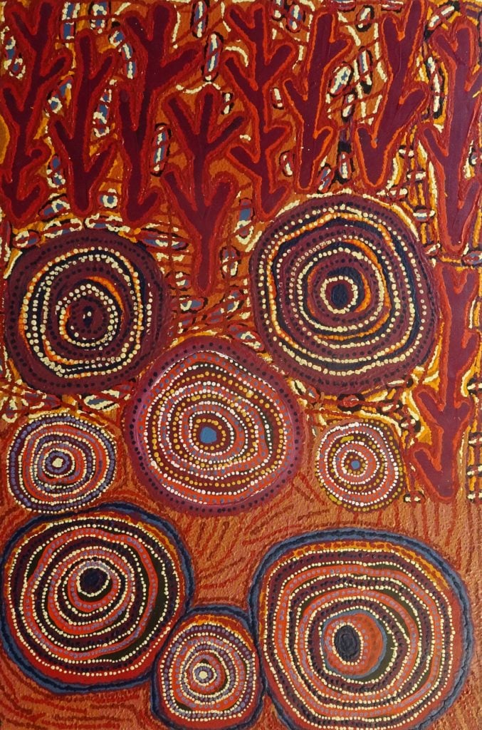 This is Pilta . Pilta is a very important story about the two wanampi (ancestoral serpents) and their two wives. The two women travelled everywhere digging for food. Each day they would dig for kuka upupilypa (tadpoles) or collect wild berries like kampurarpa. They always took food back to their two husbands. One day they got red of working so hard and thought to themselves "we might not take all this food to the men, maybe we'll eat some first". The men got angry with the women for taking so long to bring the food back and decided to trick the women by turning into water snakes.